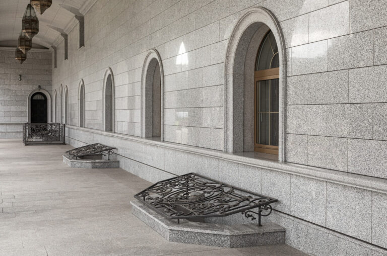 Dziedziniec z łukowymi oknami, gdzie zdobią je eleganckie parapety marmurowe.
